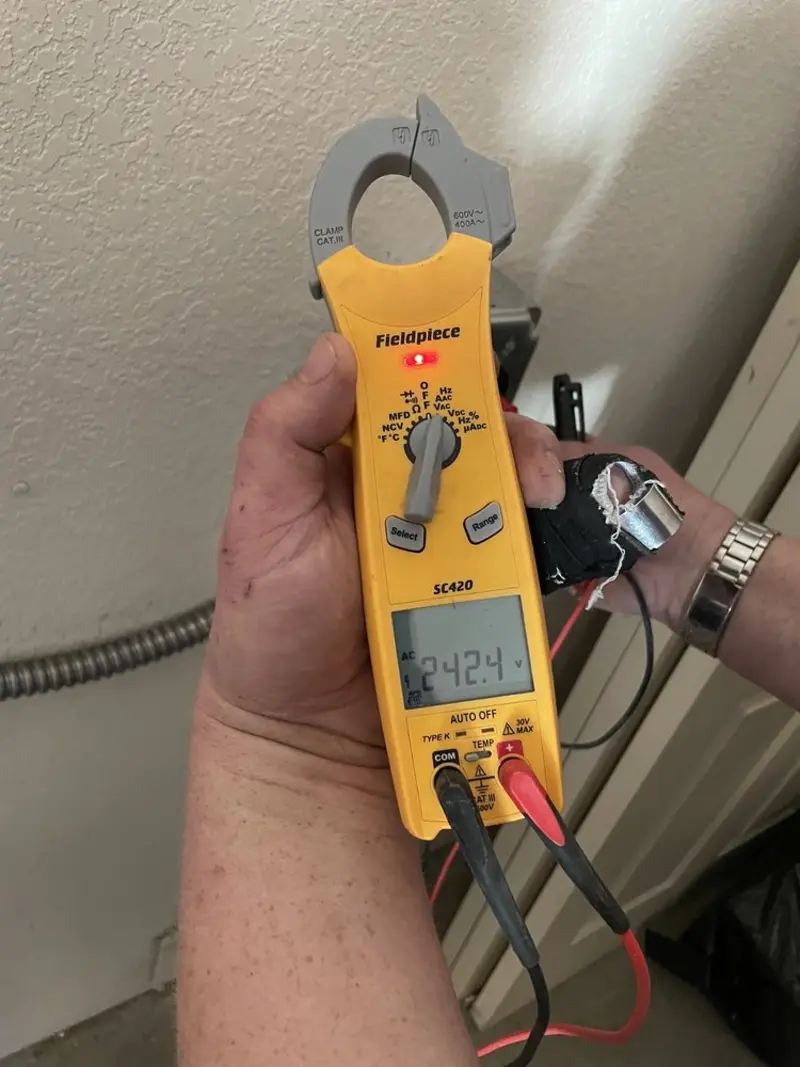 Voltage testing with clamp meter during Ceiling Fan Installation in Countryside
